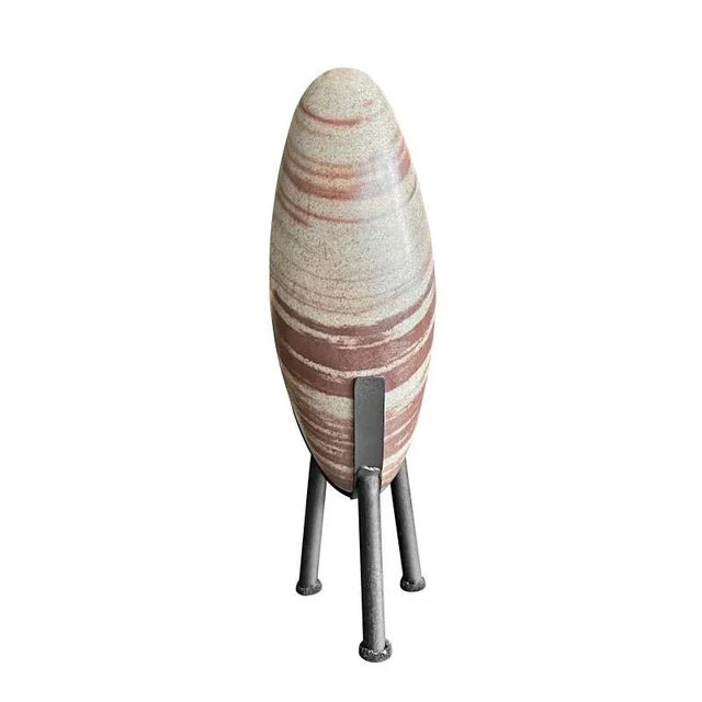 Oblong quartz rock of light grey body with large rusty brown inclusions. Shiva Lingam stones are ancient and gathered from...