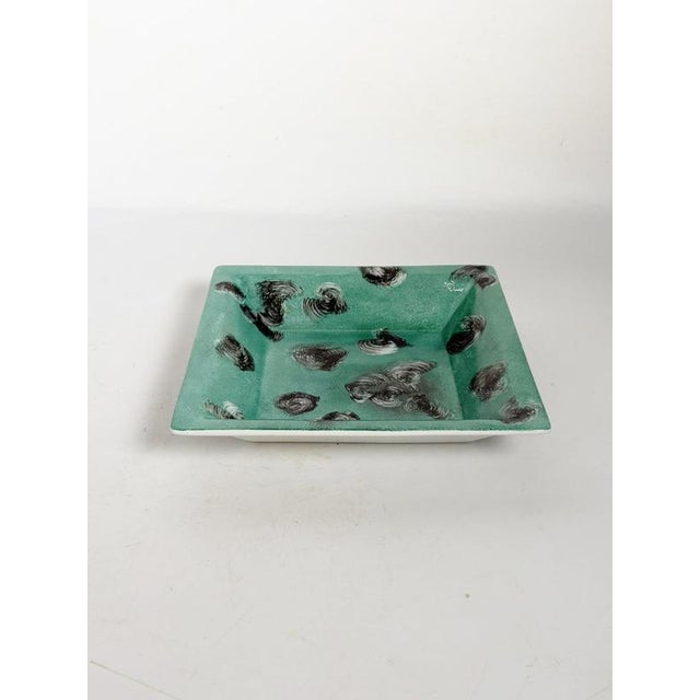 Decorative French ceramic ashtray dating from the 1970s. The rectangular form features a vibrant green glazed interior...