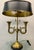 A sophisticated mid-to-late 20th-century bouillotte lamp featuring two gracefully curved, hand-finished brass French horn...