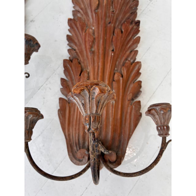 A large and unusual pair of 19th c. European carved wood three arm wall sconces. Each piece is crafted from fruitwood...