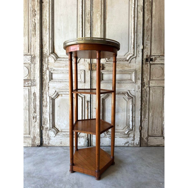 A cherrywood shelf that can serve as a side table, pedestal, or column, dating from the 1950s. It has two shelves. The...