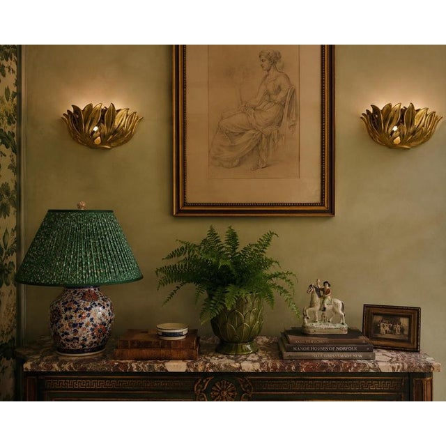 A striking pair of sculptural Italian wall sconces dating from the 1980s. Crafted in gilt metal, the sconces take the form...