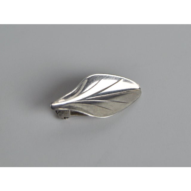 Beautiful leaf earclips with a highly polished finish in sterling silver, designed and made by the Danish goldsmith...