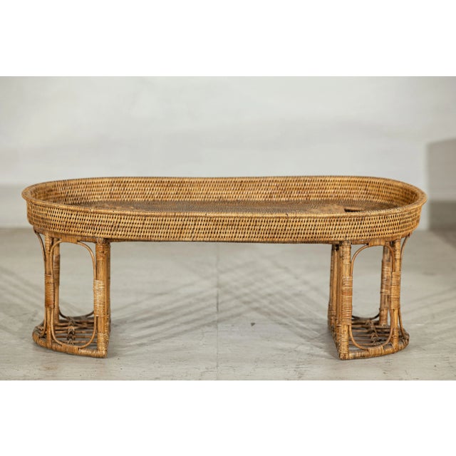 This vintage rattan table offers a versatile and charming presence, equally suited for use as a low coffee table or a...