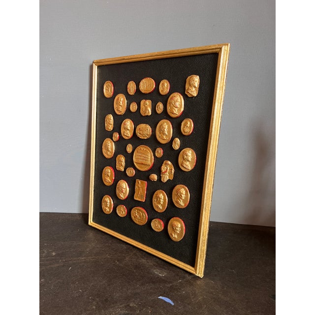 Grand Tour revival Neoclassical waxed gilded plaster collection of classical Intaglios and Cameos on the Leather Ground...