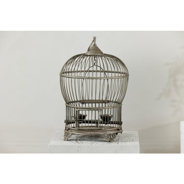 "About the Item Shaped like a hot air balloon in miniature, this antique brass bird cage floats between function and...