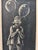 This charming scratchboard piece by Jean Henrikson features a whimsical figure holding balloons, rendered in delicate...