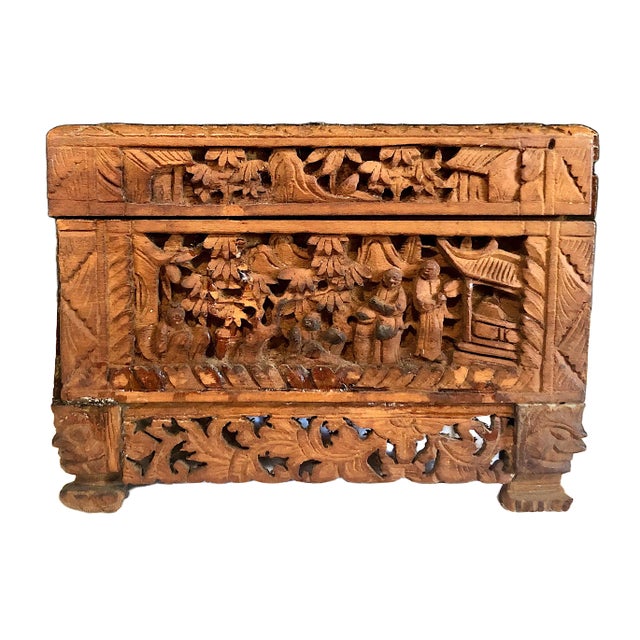 On offer is a vintage Chinese hand-carved camphor wood box with detailed courtyard, pavilion, willow, and pine scenes....