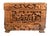 On offer is a vintage Chinese hand-carved camphor wood box with detailed courtyard, pavilion, willow, and pine scenes....