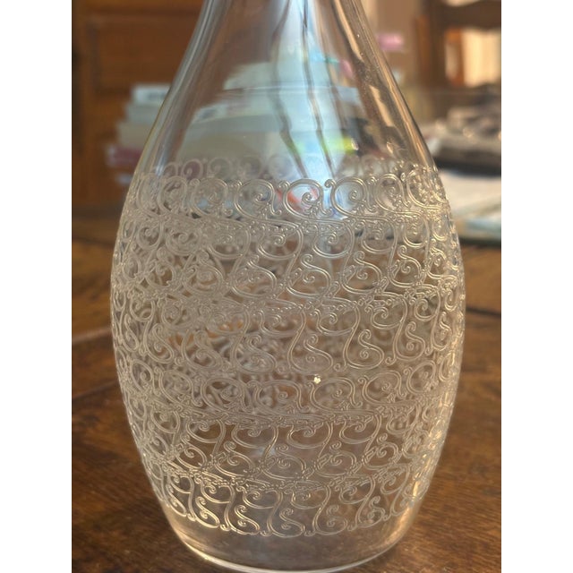 Baccarat. a slightly pear-shaped wine decanter made of fine, hand-blown, translucent crystal, featuring a rich and...