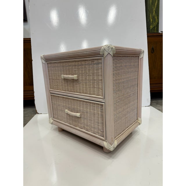 Pair of 1980's wicker and hive nightstands Glass top. Two drawers