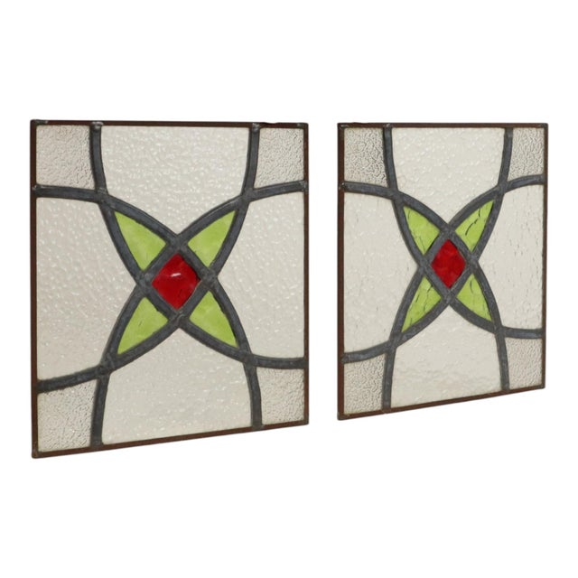 A lovely set of two vintage, narrow stained-glass panels featuring a colorful geometric pattern—perfect as suncatchers....