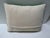 A spring green hooked pillow with Libra astrological sign.