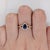 A Ceylon sapphire glows in a bright cornflower blue at the centre of this solid 14K yellow gold ring, encircled by forty-...