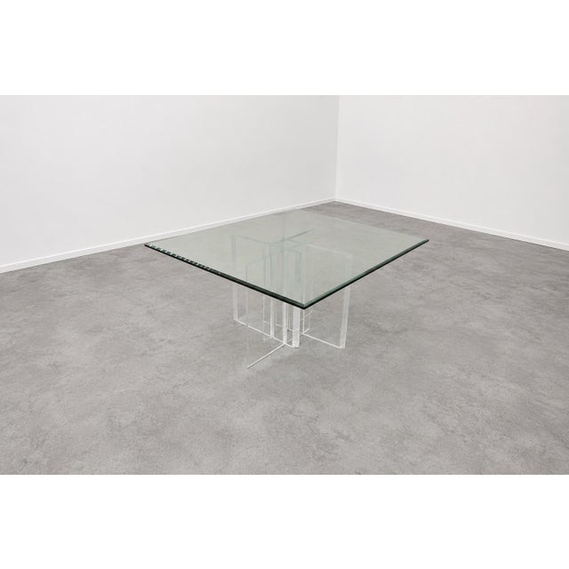 A striking 1990s square dining table attributed to Jeffrey Bigelow, featuring a substantial three-quarter-inch thick...
