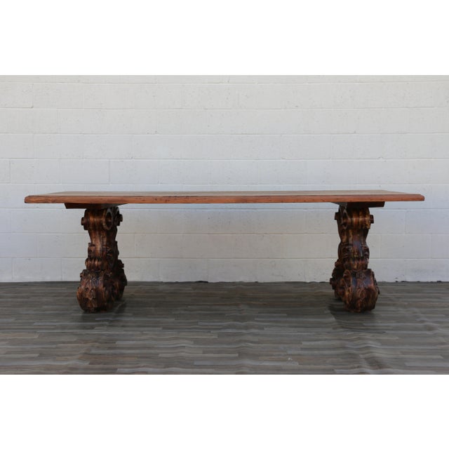 Exceptional vintage custom-made dining table dating to the 1980s, featuring a substantial solid cedar top paired with two...