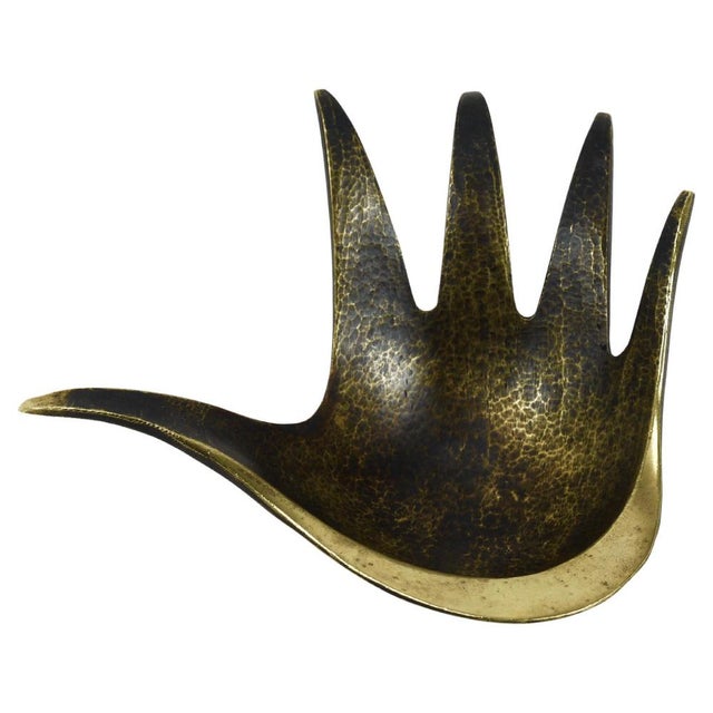 A beautiful mid-century sculptural brass bowl designed in the shape of a hand. Originally conceived as an ashtray, this...
