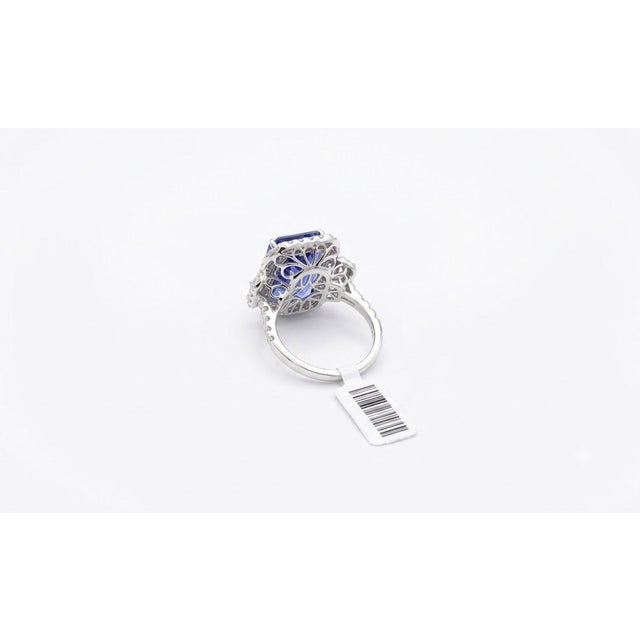 A spectacular 18K white gold cocktail ring centered around an impressive 11.70 carat natural emerald-cut tanzanite...