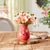 Add a pop of color and texture to your home with the Stoneware Vase with Floral Accent. Featuring vibrant bright pink...