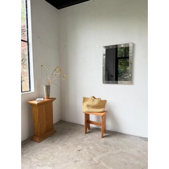 1970s mirror with a wide, brushed solid steel frame. the frame is beautifully adorned with polished steel square...