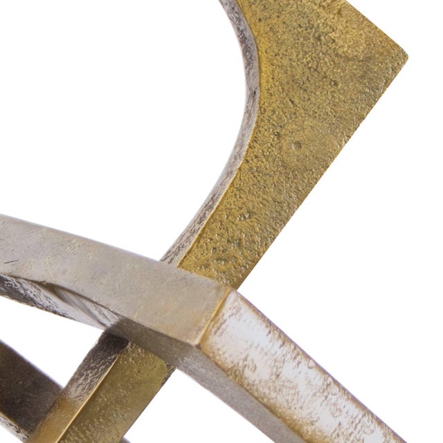 Modern and industrial, this sculpturural piece of decor has been fashioned from metal and finished in porous brass to give...