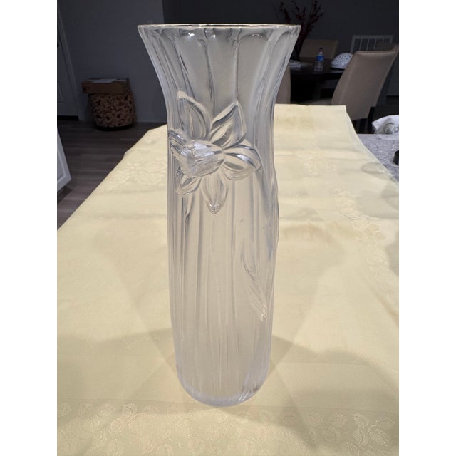This elegant crystal vase features a raised daffodil design with pinched top and clear/frosted finish. It is signed...