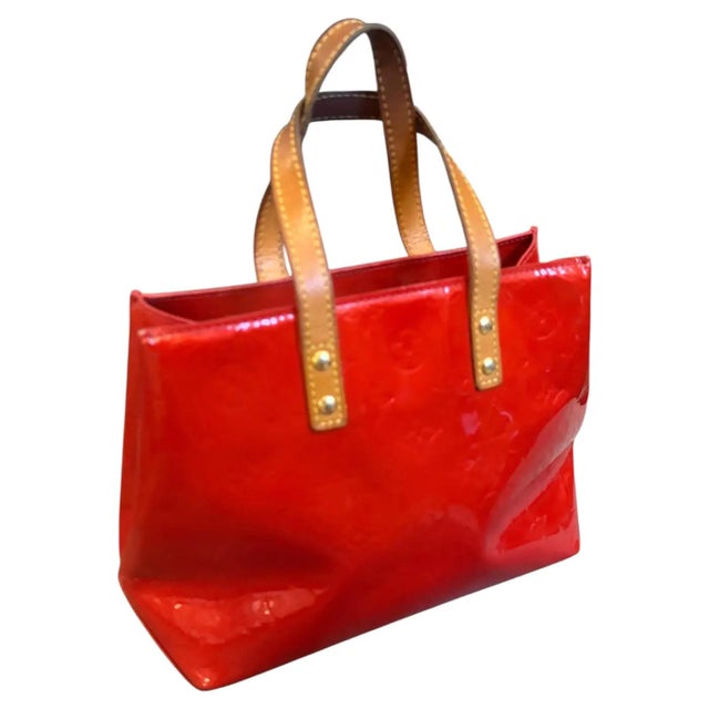 This striking Louis Vuitton Reade hand-bag is a vibrant statement piece crafted from the house's iconic Monogram Vernis...