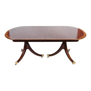 Mid 20th Century Kindel Banded Mahogany Duncan Phyfe Dining Table 4 Leaves Brass Caps on Casters For Sale
