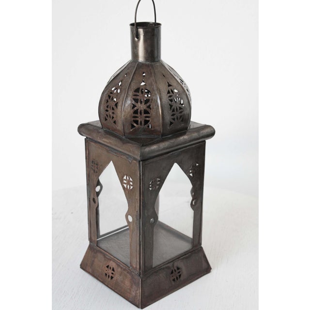 Small handcrafted Moroccan clear glass lantern adorned with open metal work Moorish filigree design. Hurricane tole candle...