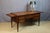 A Louis XVI style walnut desk adorned with brass moldings and featuring five drawers. The legs terminate in gilt bronze...