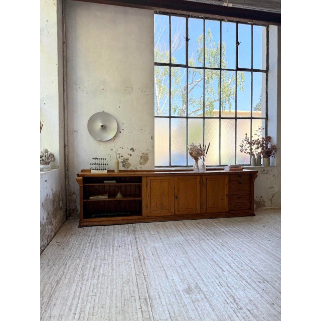 Old pine loom sideboard from the 1950s, 3 meters long. formerly used in a large grocery store, this piece of furniture has...