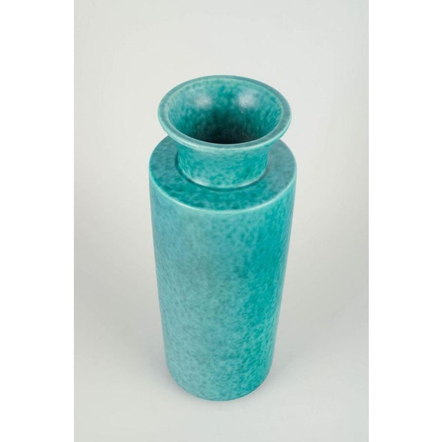 Wilhelm Kåge for Gustavsberg Turquoise glazed stoneware vase, circa 1940s. Unmarked vase of tall cylindrical form with...
