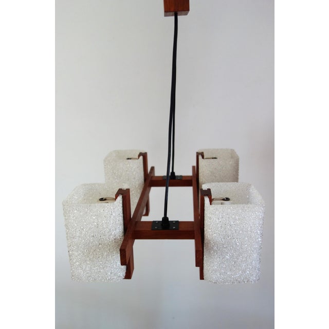 Scandinavian chandelier from the 1960s/70s. Four lights in acrylic glass (synthetic resin) and teak frame. E14 screw-in...