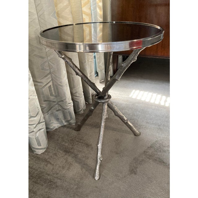 This stylish Global Views twig table features a sculptural base cast from metal to resemble intertwined branches, finished...