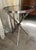This stylish Global Views twig table features a sculptural base cast from metal to resemble intertwined branches, finished...