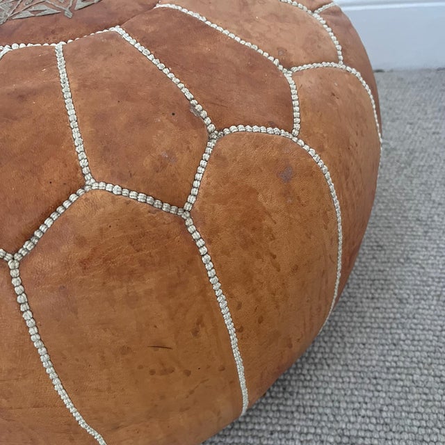 Vintage light tan leather pouffe /seat /foot stool light coloured stitching with a motif on the top 52cm diameter 30cm...