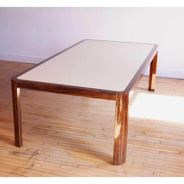 Extremely rare and beautiful 1970s Vladimir Kagan dining table featuring exotic zebrawood, aluminum inlay, and a cream...