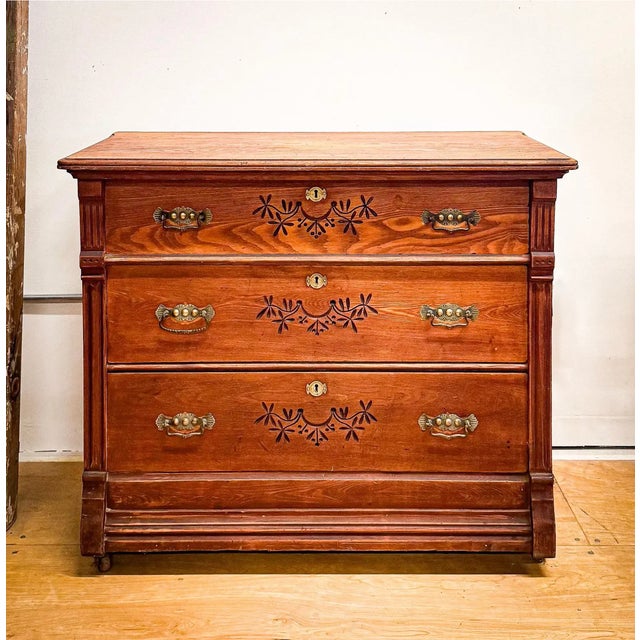 An Eastlake era dresser from the late 1800s with delicate carvings and original hardware.