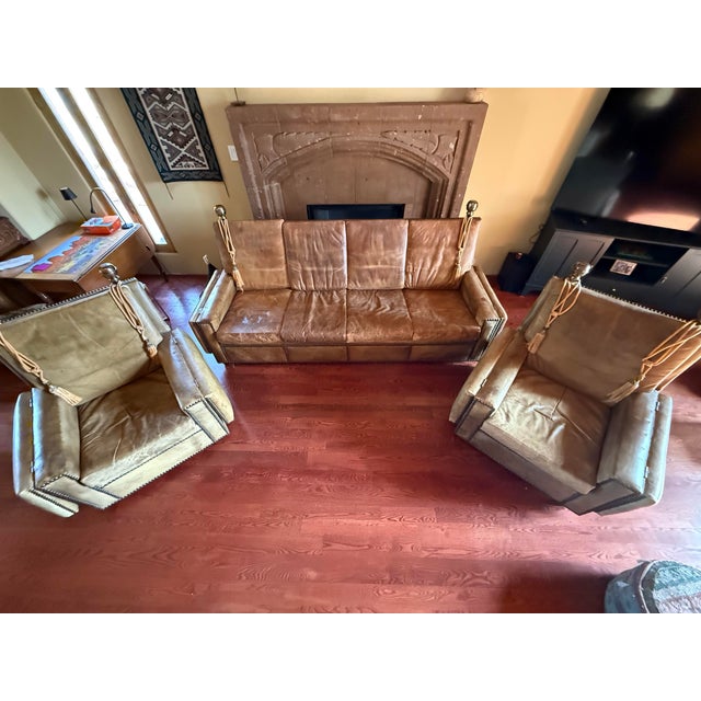 This is a set of a four seater antique Knole or Knole style sofa (no labels or tags) with two chairs. One of the key...