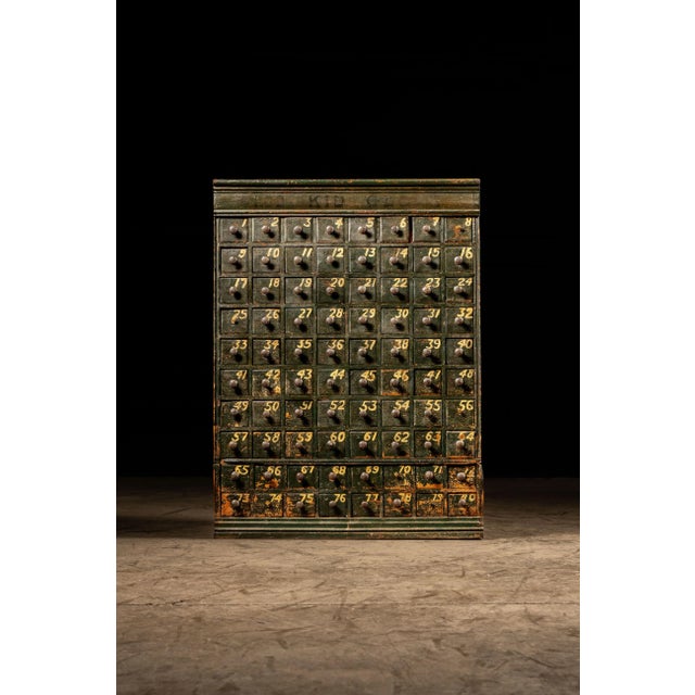 Antique oak parts cabinet with a chippy green exterior. This striking piece features 80 numbered drawers of uniform size...