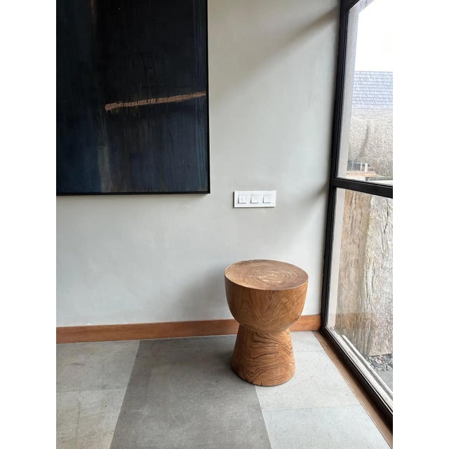 A wonderfully sculptural side table crafted from Teak Wood. Its subtly curved edges add to its charm. This table features...