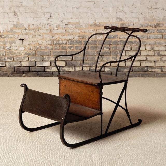 Add a unique and nostalgic touch to your space with this 19th century French iron sled with oak seat, a charming piece...