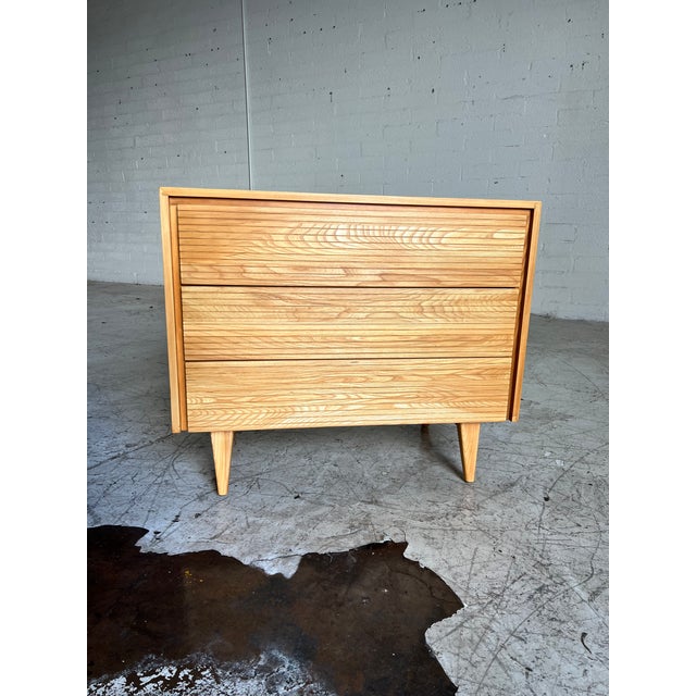 Beautifully refinished vintage chest of drawers, featuring gorgeous wood grain, three etched drawers and tapered legs. In...