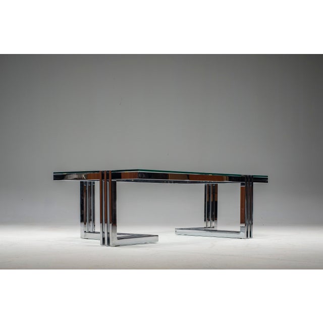 Chromed metal and frosted glass coffee table. The table's minimalist design and sturdy construction make it a versatile...