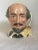This Royal Doulton Toby jug depicts William Shakespeare. The jug has a feather form handle with a building below. His...