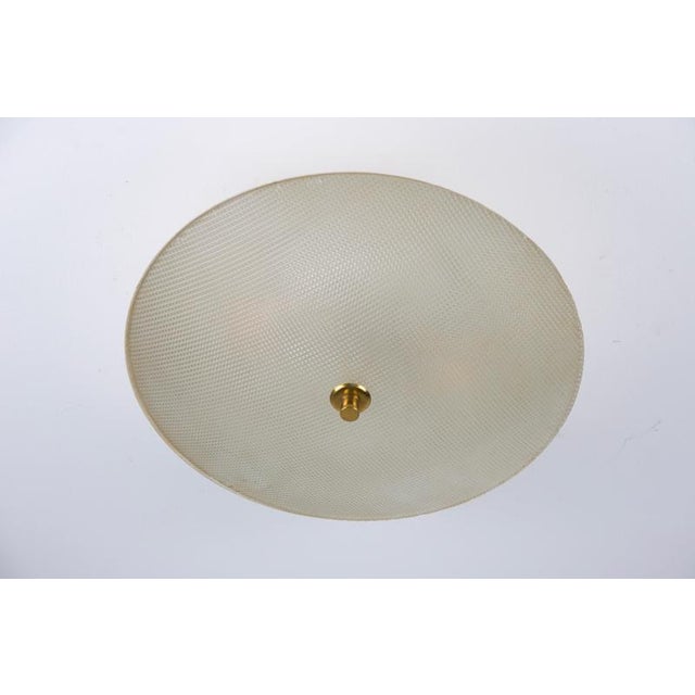 Round mid-century flush mount by stilnovo, italy, 1960s. The lamp features a clean circular form with a softly domed glass...