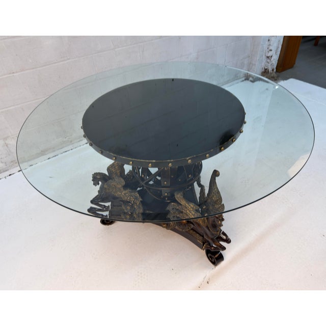 Hippocampus Mythical Table featuring a glass top and a base shaped like mythological sea horses. Features a round glass...