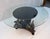 Hippocampus Mythical Table featuring a glass top and a base shaped like mythological sea horses. Features a round glass...
