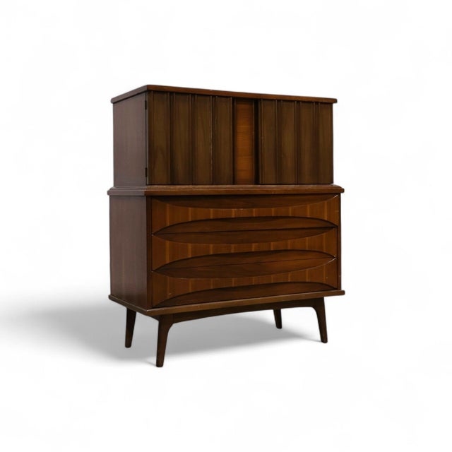 This 1960s highboy dresser by United Furniture is a perfect example of mid-century modern design. With its curved drawer...