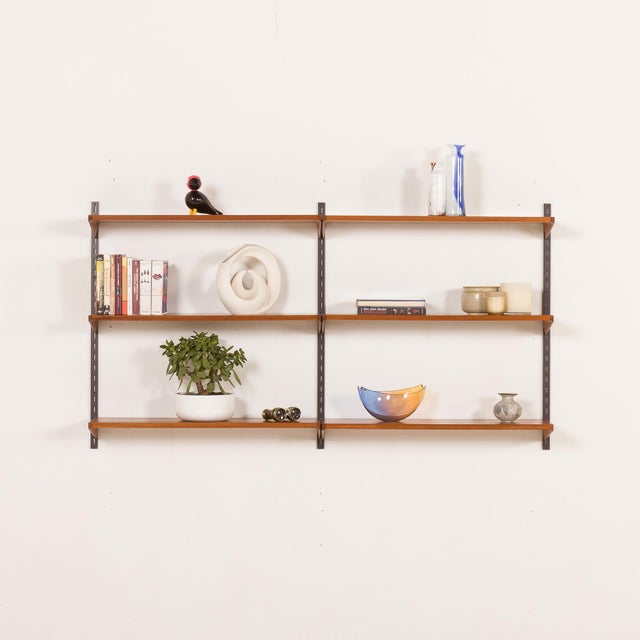 This minimalist and functional mid-century teak shelving unit, designed by kai kristiansen, an icon of danish design, was...